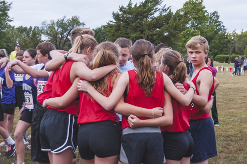 Photo of the team huddle before the start of the Emporia Cross Country Invitational.